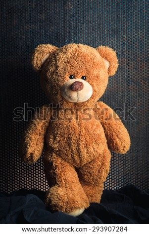 Cute teddy bear with old metal background