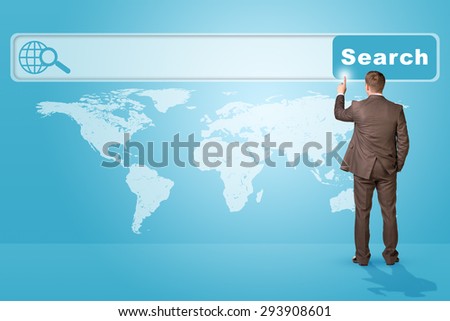 Businessman standing and pressing on browser on abstract blue background with world map, rear view