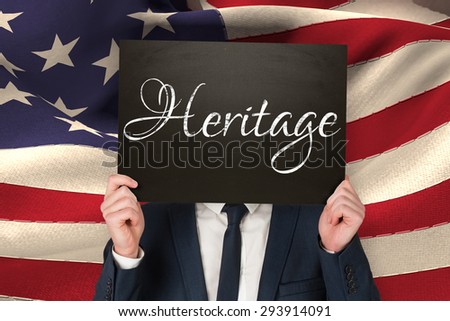 Businessman holding board against heritage