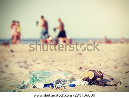 Retro filtered garbage on a beach left by tourist, environmental pollution concept picture, Baltic Sea, Poland.