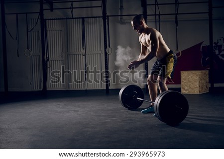 Athlete motivates screaming before barbells exercise at gym Royalty-Free Stock Photo #293965973