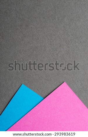 Blue and pink color paper sheets on grey background