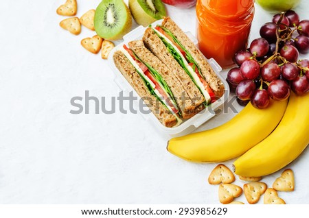 school lunch with a sandwich, fresh fruits, crackers and juice. the toning. selective focus Royalty-Free Stock Photo #293985629