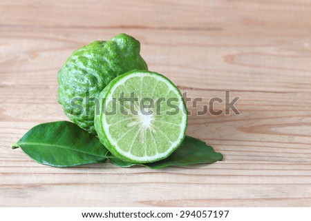 Bergamot with green leafs on wood background