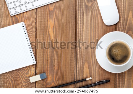 Office desk table with computer, supplies and coffee cup. Top view with copy space
