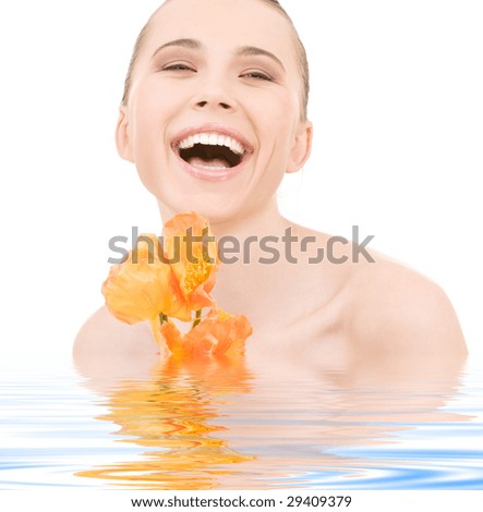 picture of laughing woman with flowers in water