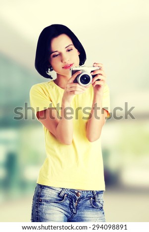 Happy woman holding a camera