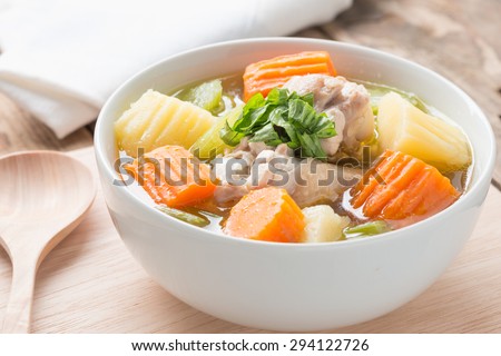 Chicken soup in white bowl.