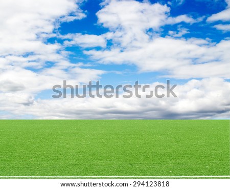 football field blue sky with clouds