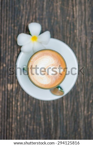 Top view of offee cup and flower on old wooden background, Coffee cup tree leaves