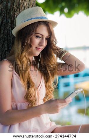 Smiling young woman with mobile phone