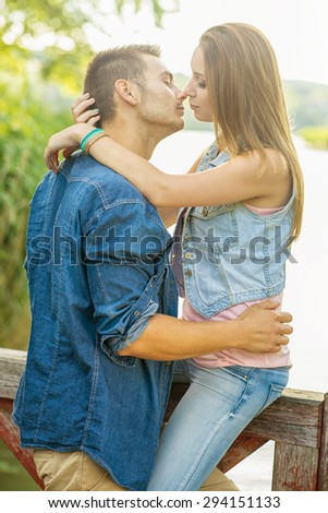 Couple in love on the lake, hug, close-up