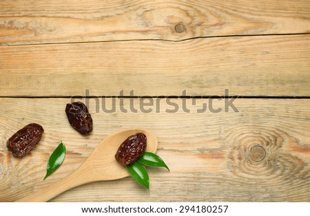 Still life, food and drink, holidays concept. Ramadan dates on a wooden table. Selective focus, copy space background, top view