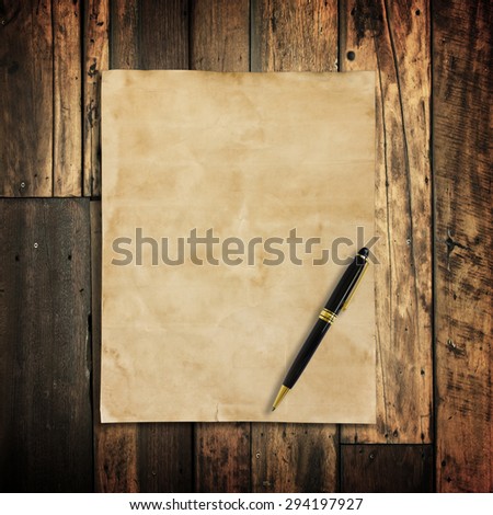 old brown paper and pen on wooden wall background for texture.