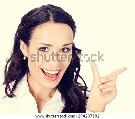 Happy smiling young businesswoman showing blank area for sign or copyspase