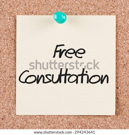 Reminder sticky note on cork board with FREE CONSULTATION text