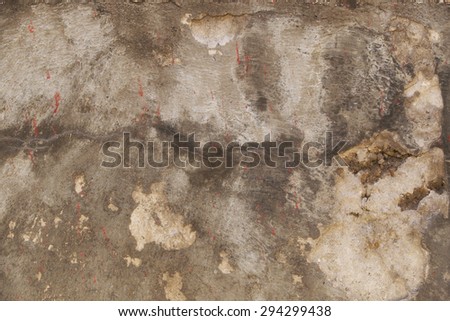 Old concrete wall with cracks and potholes