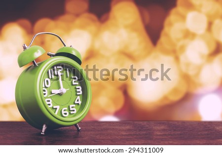 Clock on Wooden Floor with Yellow Bokeh Background , Vintage Style