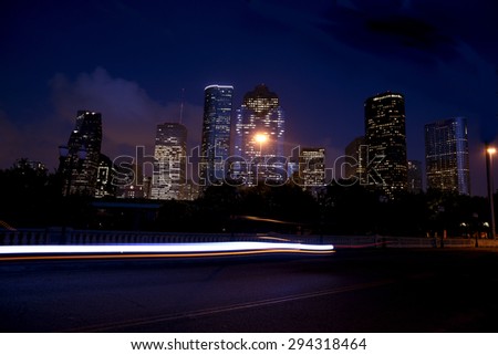 Downtown Houston at night with moving traffic