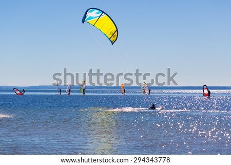Kite surfer swimming in sea. Beautiful summertime photo of kite surfer swim on sea surface
