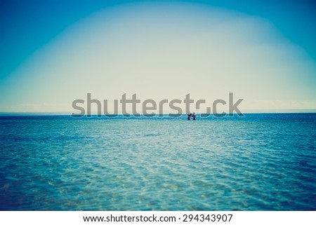 Man swimming in sea. Summertime photo of man standing in sea water