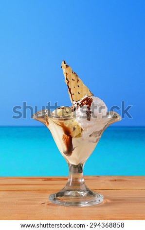 Cup of ice cream with sea in the background