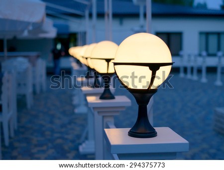 Row of Patio Lights Illuminating Soft Light Outdoors at Dusk