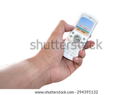 Human hand holding vintage phone shooting picture isolated on white background with image of colorful umbrella