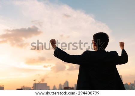 Victorious man in the city. Royalty-Free Stock Photo #294400799
