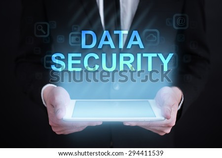 Businessman holding a tablet pc with "Data security" text on virtual screen. Internet concept. Business concept.