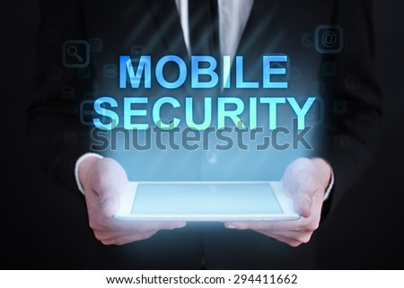 Businessman holding a tablet pc with "mobile security" text on virtual screen. Internet concept. development. 