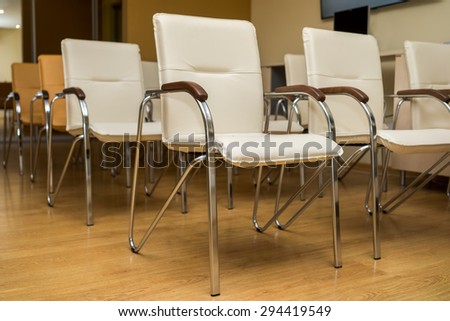 white chairs in a row in conference room 