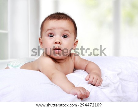 portrait of cute little baby on the bed