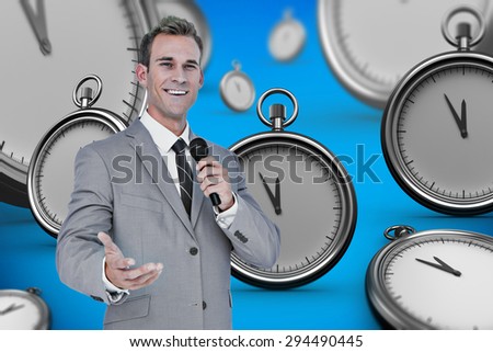 Businessman giving speech against blue background with vignette