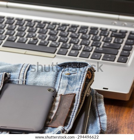The black tablet in pocket of jeans