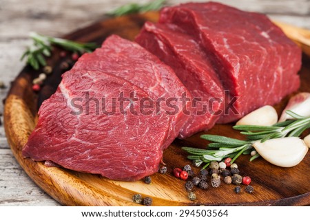 Raw beef meat on a cutting board Royalty-Free Stock Photo #294503564