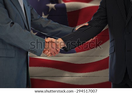 Handshake in agreement against white wood