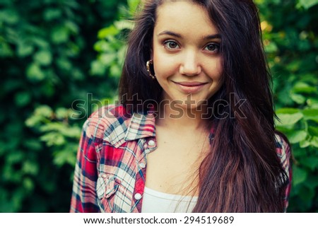 Brown hair girl  in the park and posing to the picture