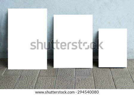 three white poster on wall