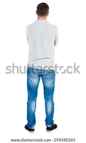 Back view of man in jeans. Standing young guy. Rear view people collection.  backside view of person.  Isolated over white background. A guy in a gray sweater standing with his arms crossed.