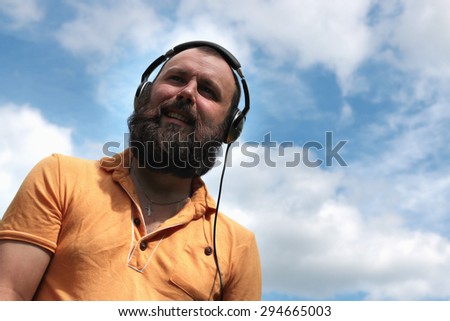 DJ with headphones on the sky background