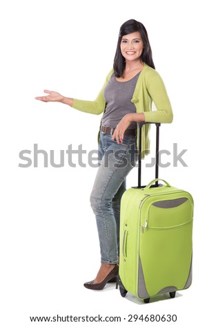 A portrait of beautiful middle aged asian woman holding suitcase. presenting copy space