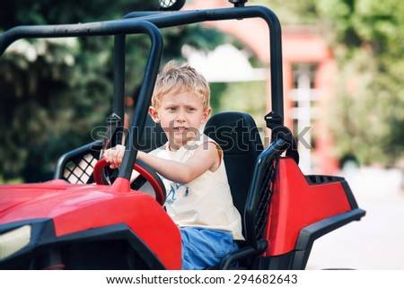 Boy drive a toy electric car 