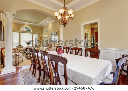 Extremely elegant dinning area with large table and many chairs.