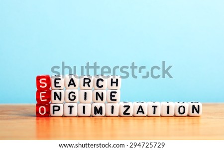 SEO Search Engine Optimization written on dices  on blue background