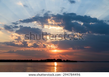 Summer Sunrise With Beautiful Cloudy Sky Over Calm Lake Water