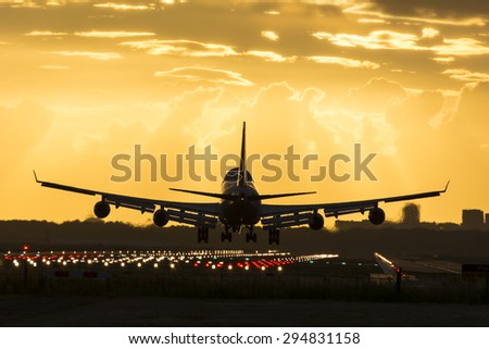 Huge plane is landing on the runway. Royalty-Free Stock Photo #294831158