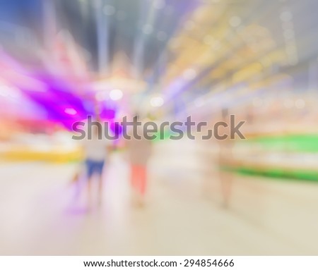 Blurred image of people walking at shopping mall , blur background with bokeh .