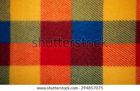 Multicoloured fabric with many quadrates. Many colours are repeated.