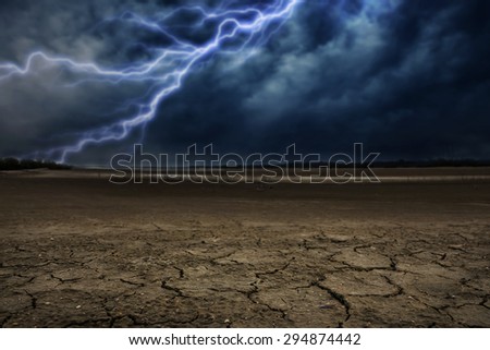 Land to the ground dry and cracked. With lightning storm Royalty-Free Stock Photo #294874442